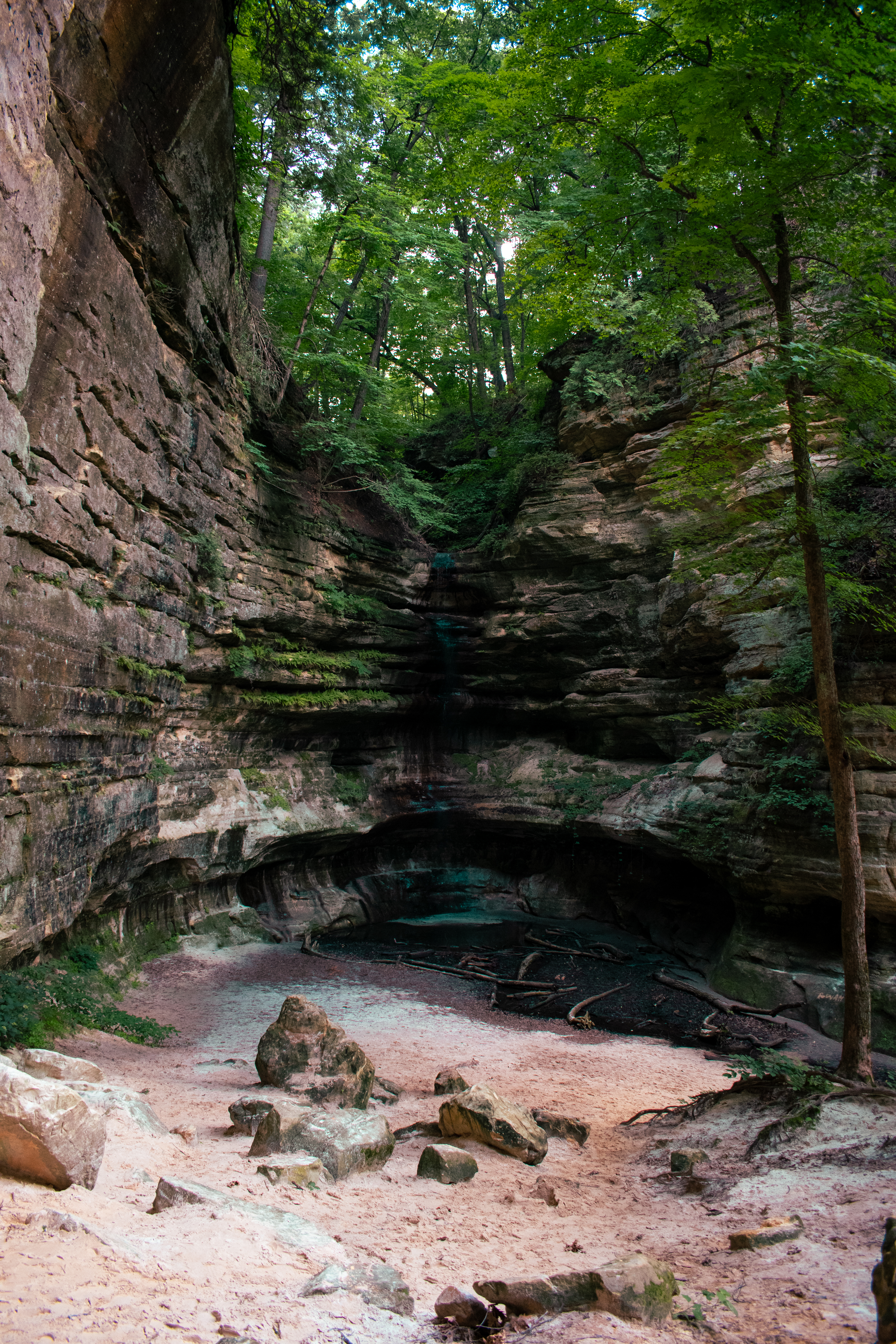 Canyon with faint waterfall and sandy floor